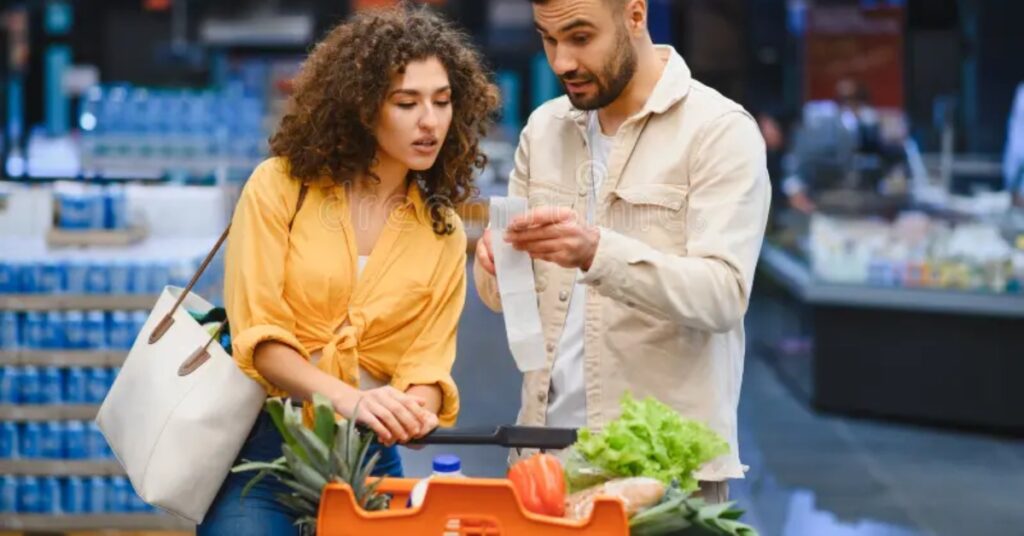 America economy problems shown through a stressed middle-class family facing unpaid bills, high grocery prices, and rising cost of living at kitchen table