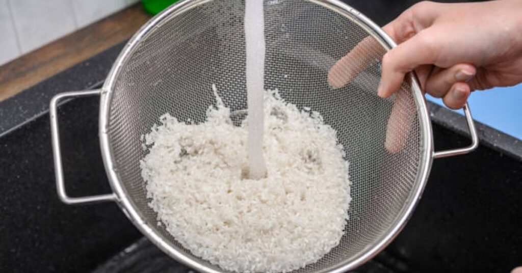 “Washing basmati rice in clear water for easy vegetable biryani recipe in clean kitchen”