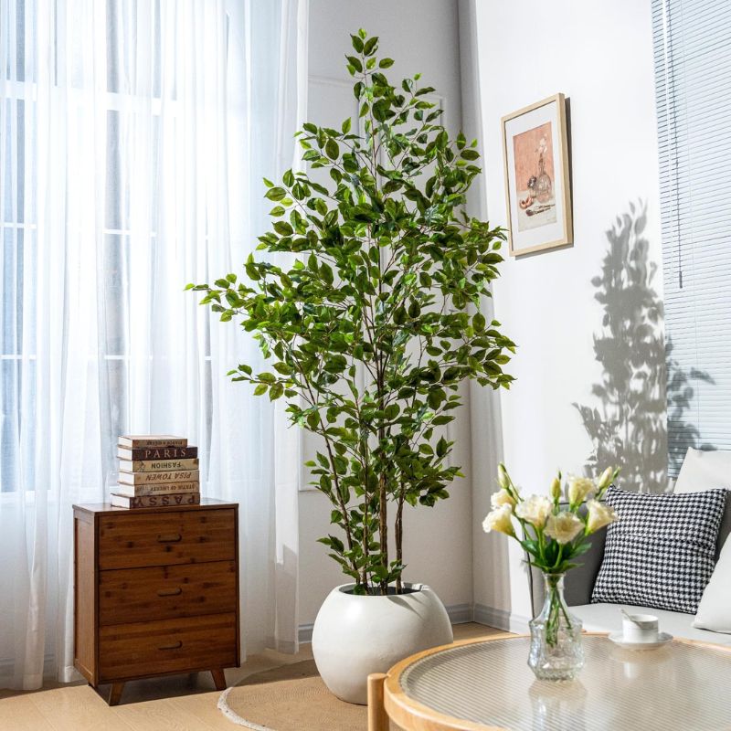 Green artificial plants enhancing cozy and modern living room aesthetic.