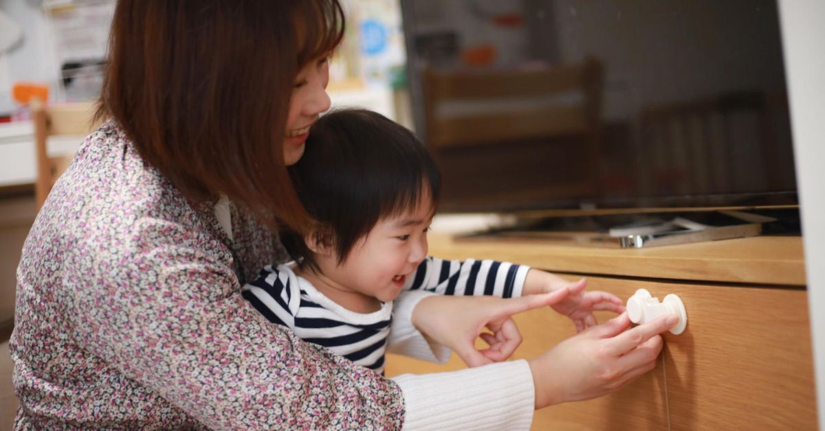 “Child safety at home with babyproofed living room, outlet covers, safety gates, and secure furniture”