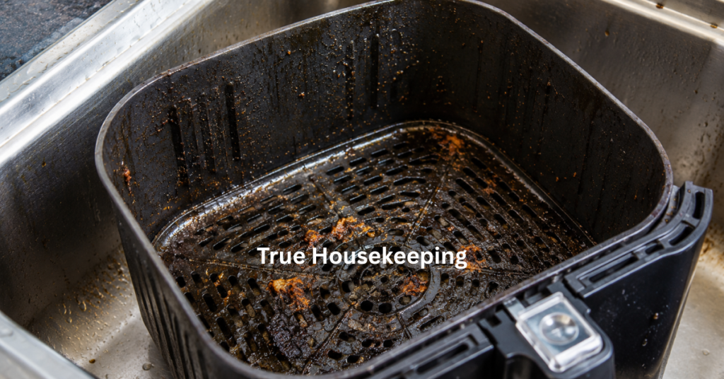 Dirty air fryer basket with grease and burnt food buildup