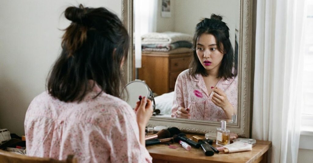 Red lipstick stain on cream blouse with cleaning supplies